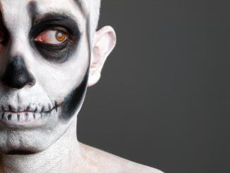 man's face painted with a skull