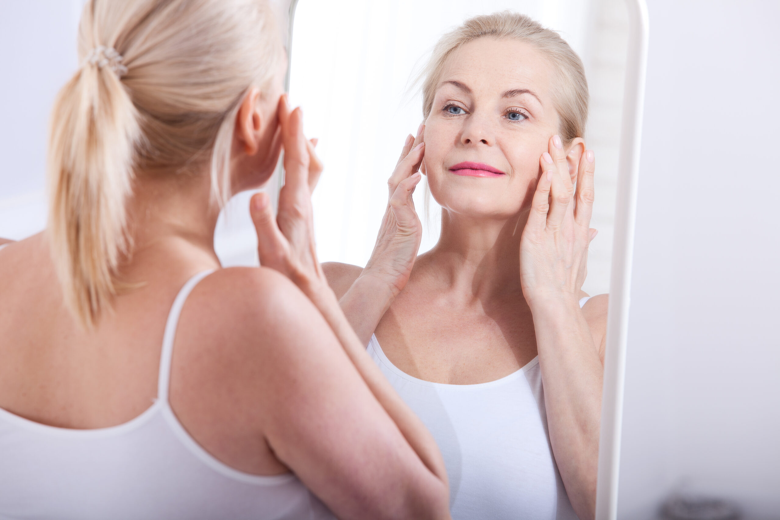 Woman looking into mirror